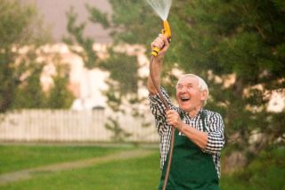 senior-gardener-with-water-hose.jpg